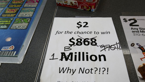 An updated sign is at the counter of a 7-Eleven store shows that the Mega Millions estimated jackpot has soared to $US1 billion.
