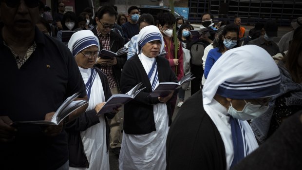 Women of the cloth listen to a service and pray outside St Paul’s Cathedral after the Good Friday ‘Stations of the Cross’ walk.