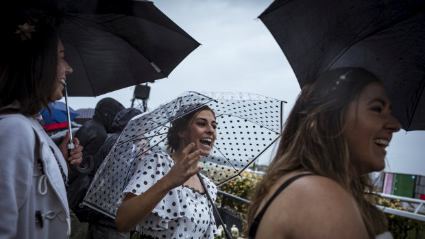 An umbrella was the accessory du jour for Jenna Peldys, Jane De Lorenzo and Kate Peldys from Ballarat. 