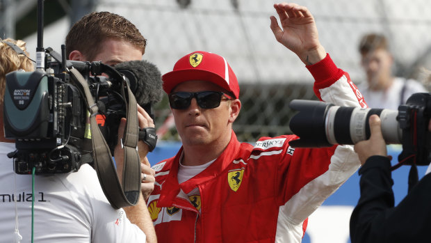Blistering: Ferrari's Kimi Raikkonen waves at fans after taking pole in qualifying for the Italian Grand Prix.