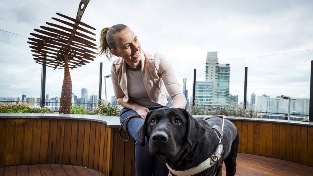 Stephanie Campbell, who experienced discrimination in her work as a real estate agent after losing her vision, with her assistance dog Rocky.