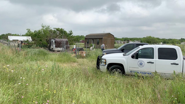 Medical examiners investigate Freddie Mack's home in Venus, Texas. Investigators later determined he was eaten by his dogs.