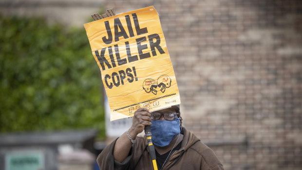 Steven Hudson protests near the site where a black man, who was taken into police custody the day before, died. 