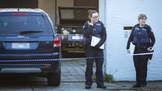 Police stand guard at the residence in Princess St, Kew.