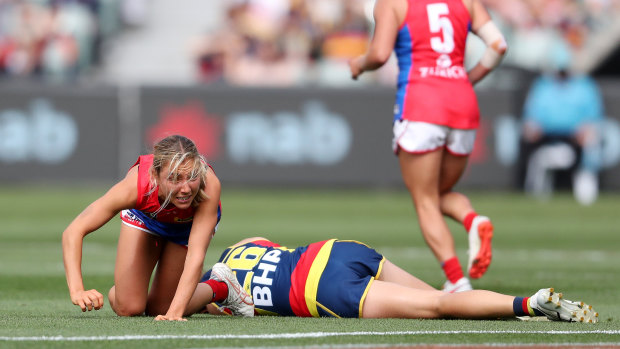 Melbourne’s Eliza McNamara and the Crows’ Chelsea Randall after a heavy clash.