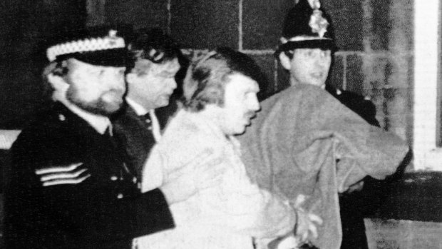 Peter Sutcliffe, under a blanket, as he was led from court in 1981.