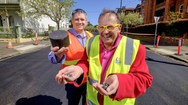 Port Phillip mayor Dick Gross and Fulton Hogan's Peter Curl with plastic used to resurface Mozart Street. 