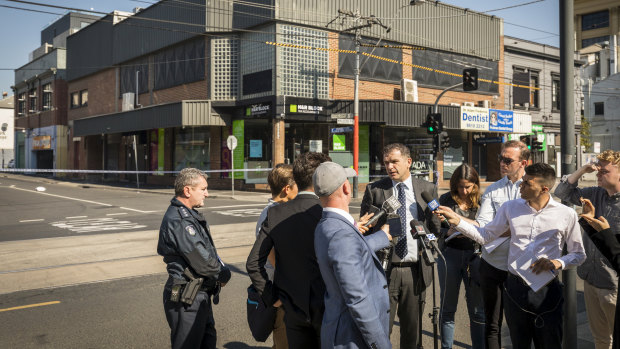 Detective Inspector Andrew Stamper addresses media at the scene of the shooting. 