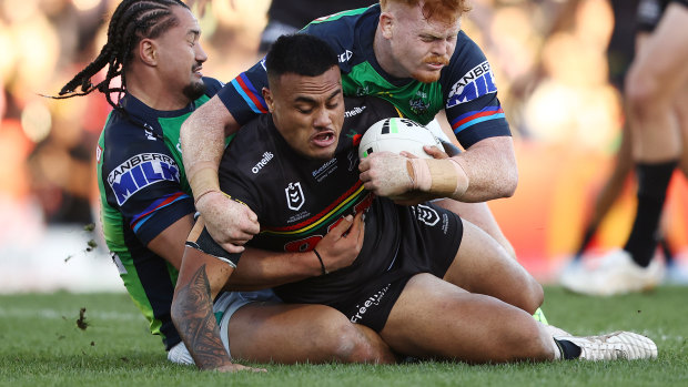 Spencer Leniu tries to wrestle past the Raiders defence.