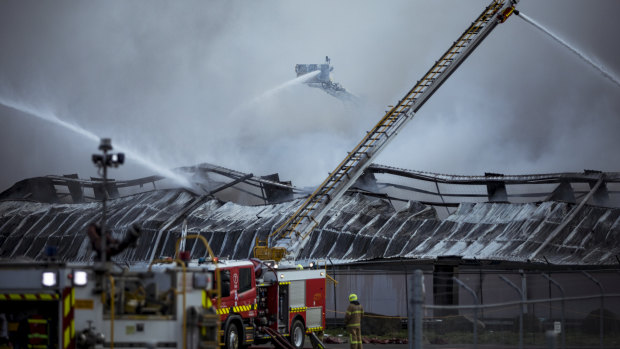 Firefighters battle the blaze at e-waste facility MRI E-Cycle on August 9
