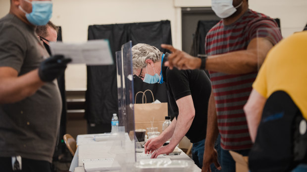 An election official helps voters at a polling station in Philadelphia, Pennsylvania, US. 