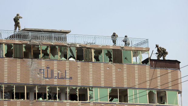 Security personnel on top of the prison where insurgents were hiding.