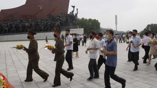 Masks are visible as people visit the Mansu Hill to pay respects to the late North Korean leaders Kim Il-sung and Kim Jong-il in Pyongyang, North Korea.