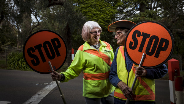 Lollipop ladies Pam Pryor (left) and Pam Ramadge have been supervising crossings on opposite sides of Melbourne for 45 years.
