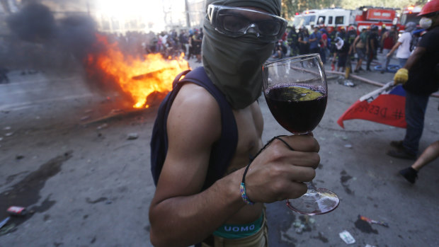 A protester poses with a glass of wine during the strike on Tuesday.