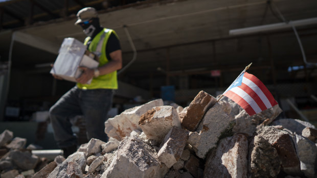 A Puerto Rican flag sits in a pile of rubble after a 6.4 earthquake hit just south of the island in January. 