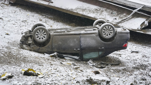 A car lies upside down after the bridge collapsed.
