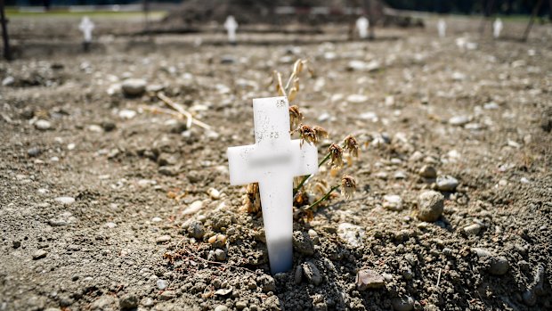 White crosses delimiting the areas for new burials are scattered at the Maggiore cemetery in Milan. The country's death toll topped 25,000 this week.