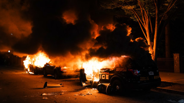 Cars burn during a protest in Atlanta on Friday.