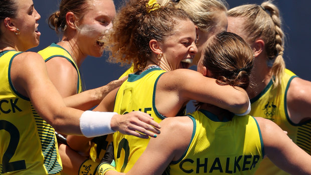 Emily Chalker is hugged by Ambrosia Malone and mobbed by her teammates after scoring yet another goal.