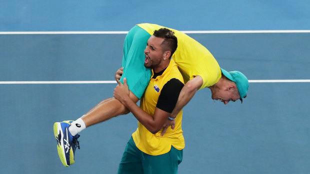 Nick Kyrgios slings Alex de Minaur over his shoulder after the win over Great Britain at the ATP Cup. 
