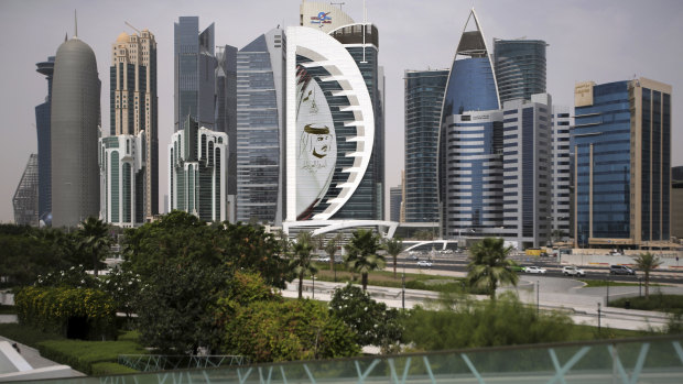 A giant image of the Emir of Qatar, Sheikh Tamim bin Hamad al-Thani, adorns a tower in Doha.