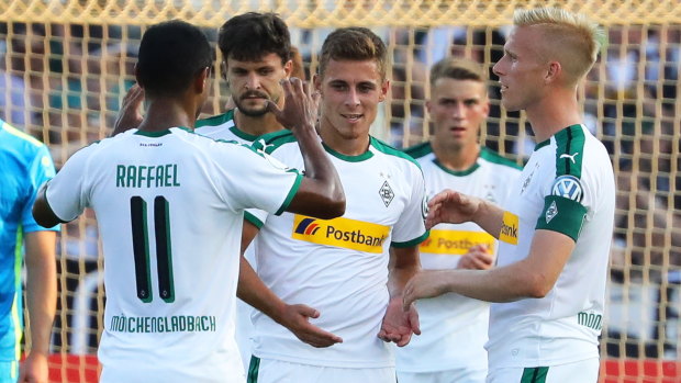 Borussia Moenchengladbach's Thorgan Hazard (centre) celebrates his side's sixth goal.