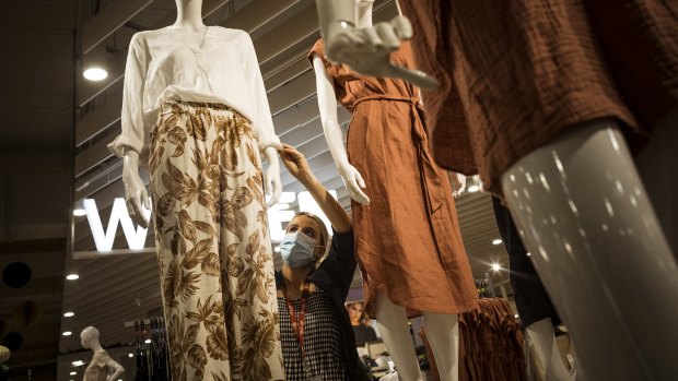 Madison Morgan makes sure the mannequins are looking good ahead of Target’s reopening. 