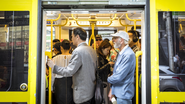 Commuters pack into a crowded tram along Bourke Street during the lunchtime break earlier this month.
