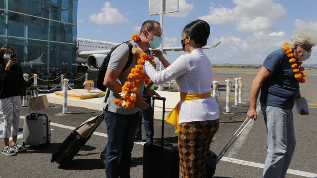 A passenger being welcomed at Denpasar airport in Bali after the resort island reopened its borders to tourists on July 31.