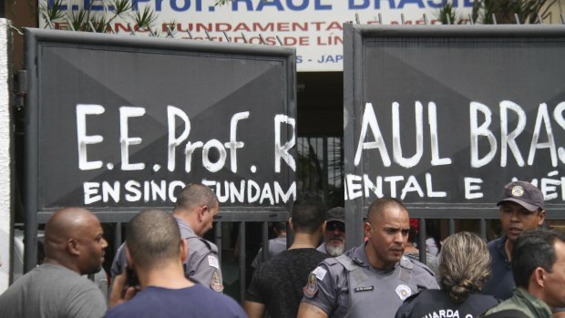 Police officers guard the entrance to the Rual Brasil State School.