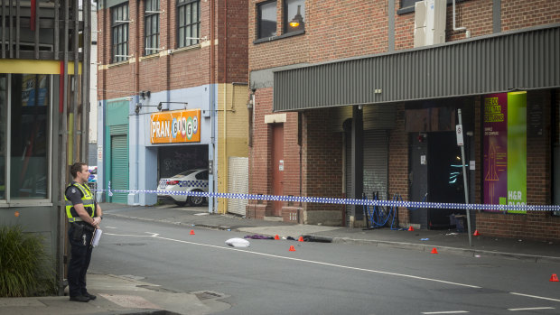 Police officers at the scene on the morning after the fatal shooting.