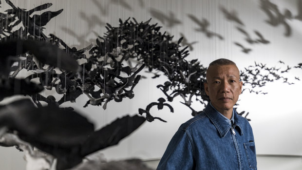 Cai Guo-Qiang with his installation of 10,000 porcelain birds.