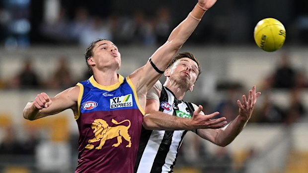 Brisbane's Eric Hipwood, who kicked two goals, and Jordan Roughead of the Magpies battle for the ball on Friday night. 