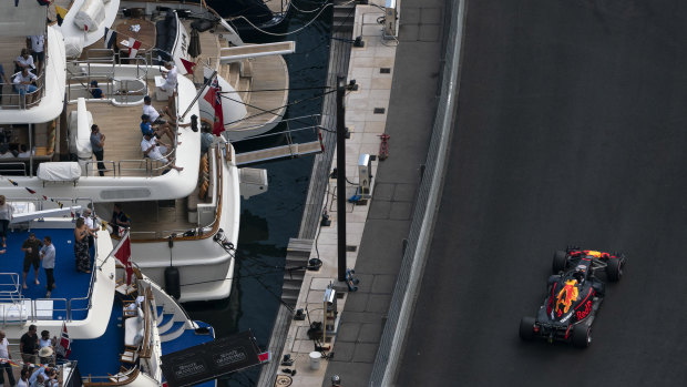 The glamour of Monaco: Daniel Ricciardo races past luxury yachts.