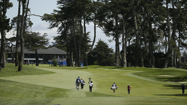 Minjee Lee, right, of Australia, walks up the fifth fairway of the Lake Merced Golf Club.