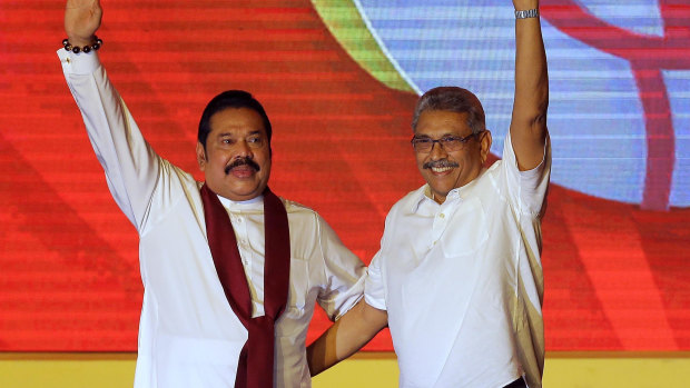 Mahinda Rajapaksa, left, and his brother Gotabaya Rajapaksa wave to supporters during a party convention n Colombo last year.