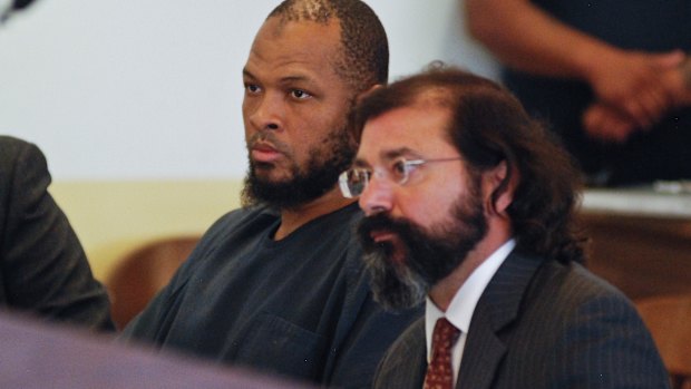 Siraj Ibn Wahhaj, left, sits next to public defense attorney Aleks Kostich at a first appearance in New Mexico state district court in Taos, NM.