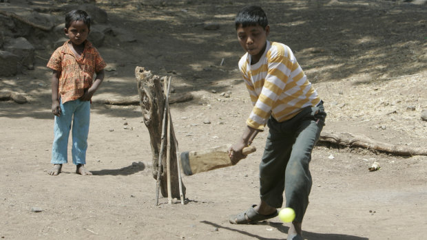 Village children play cricket in the street. Calls are growing for affirmative action to give more cricketers from a lower caste in India an opportunity to play for their country. 
