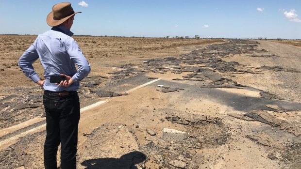 Main Roads Minister Mark Bailey inspects damage on the Flinders Highway, east of Julia Creek.