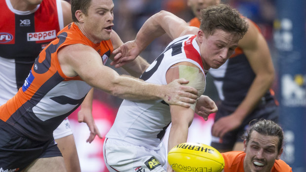 Scrap for possession: Heath Shaw of the Giants tackles Jack Billings.