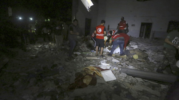 Libyan Red Crescent workers recover migrants bodies after an air strike at a detention centre in Tajoura, east of Tripoli.