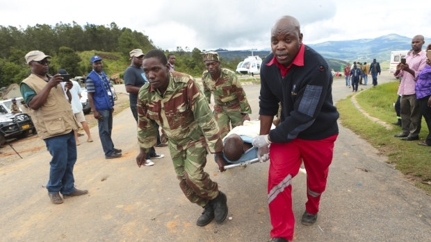 Soldiers and paramedics carry injured survivors from a helicopter in Chimanimani, about 600 kilometres south-east of Harare, Zimbabwe, on Tuesday.