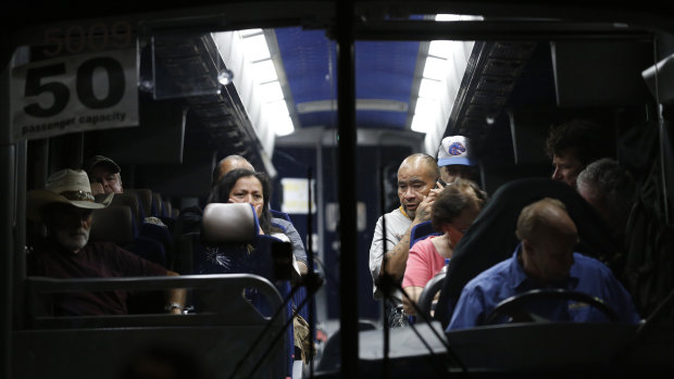 Festival attendees are taken away on a bus following a shooting at the Gilroy Garlic Festival on Sunday.