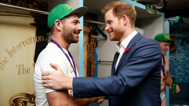 Spoils of victory: Springboks fullback Willie Le Roux meets Prince Harry in the winners' dressing room.