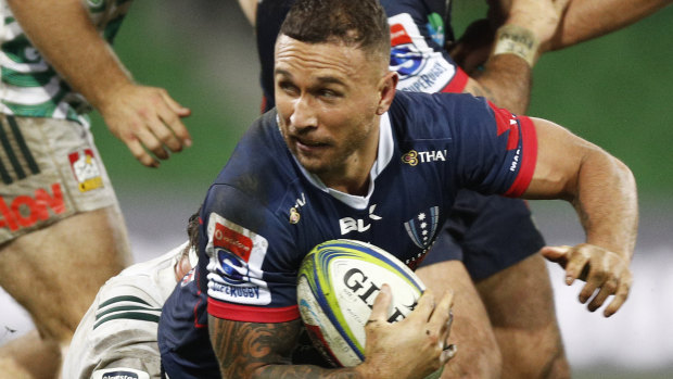 Hard day at the office: Quade Cooper of the Rebels is tackled on Friday night.