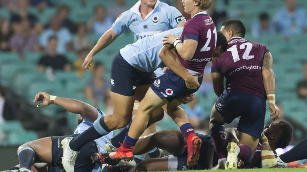 Hardening up: Israel Folau drives back Tate McDermott in the tackle.