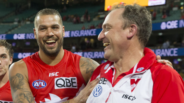 Winners are grinners: Lance Franklin and John Longmire celebrate victory over West Coast on Sunday.