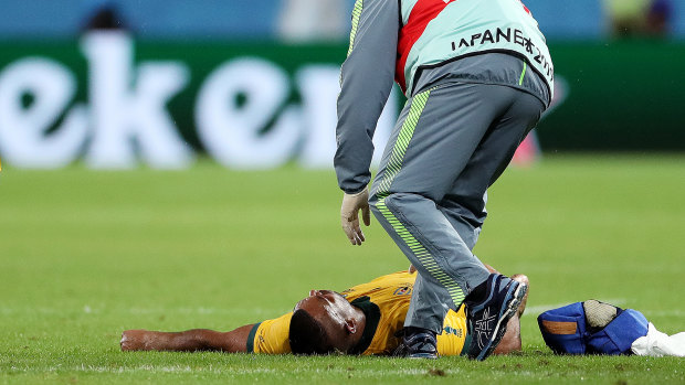 Kurtley Beale is treated by medical staff after copping a head knock during Australia's win over Georgia in Shizuoka. 