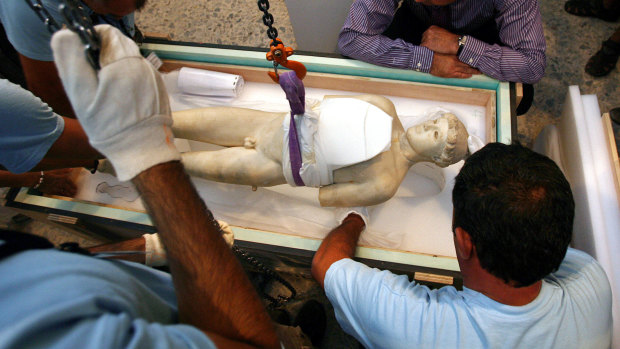 Technicians of Greek Culture Ministry remove the Kritios Boy, a 480 B.C. statue of a youth from the old Acropolis Museum being moved to a new museum.